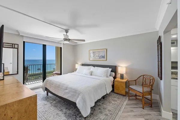 a bedroom with a bed a table and flat screen tv