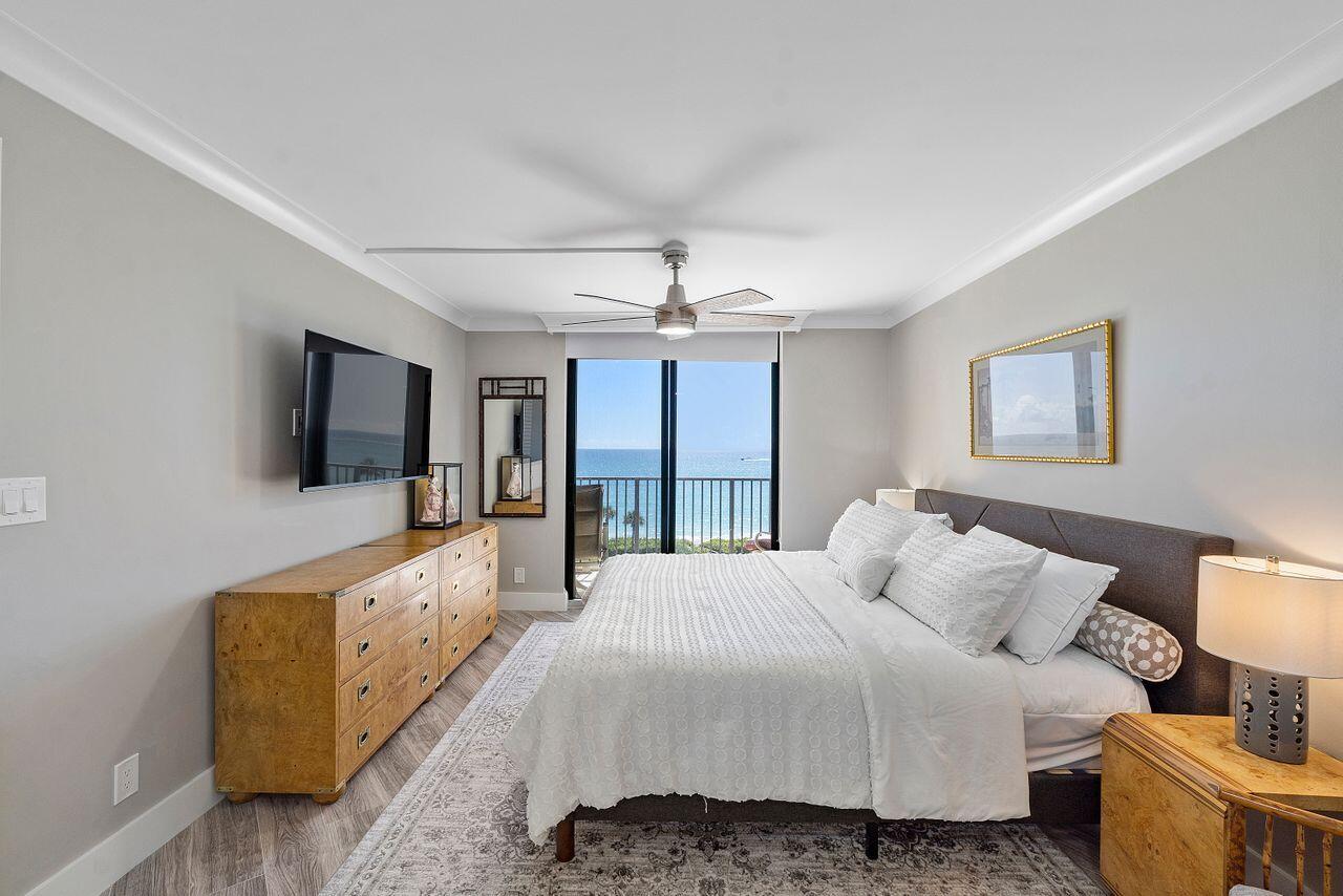 200 Ocean Trail Way, Unit 602 Jupiter, FL 33477 - Photo 17 of 50 a spacious bedroom with a bed and a flat screen tv