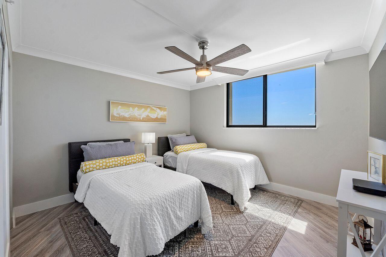 200 Ocean Trail Way, Unit 602 Jupiter, FL 33477 - Photo 28 of 50 a bedroom with two beds and a ceiling fan