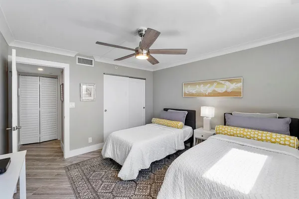 a bedroom with two beds and a window