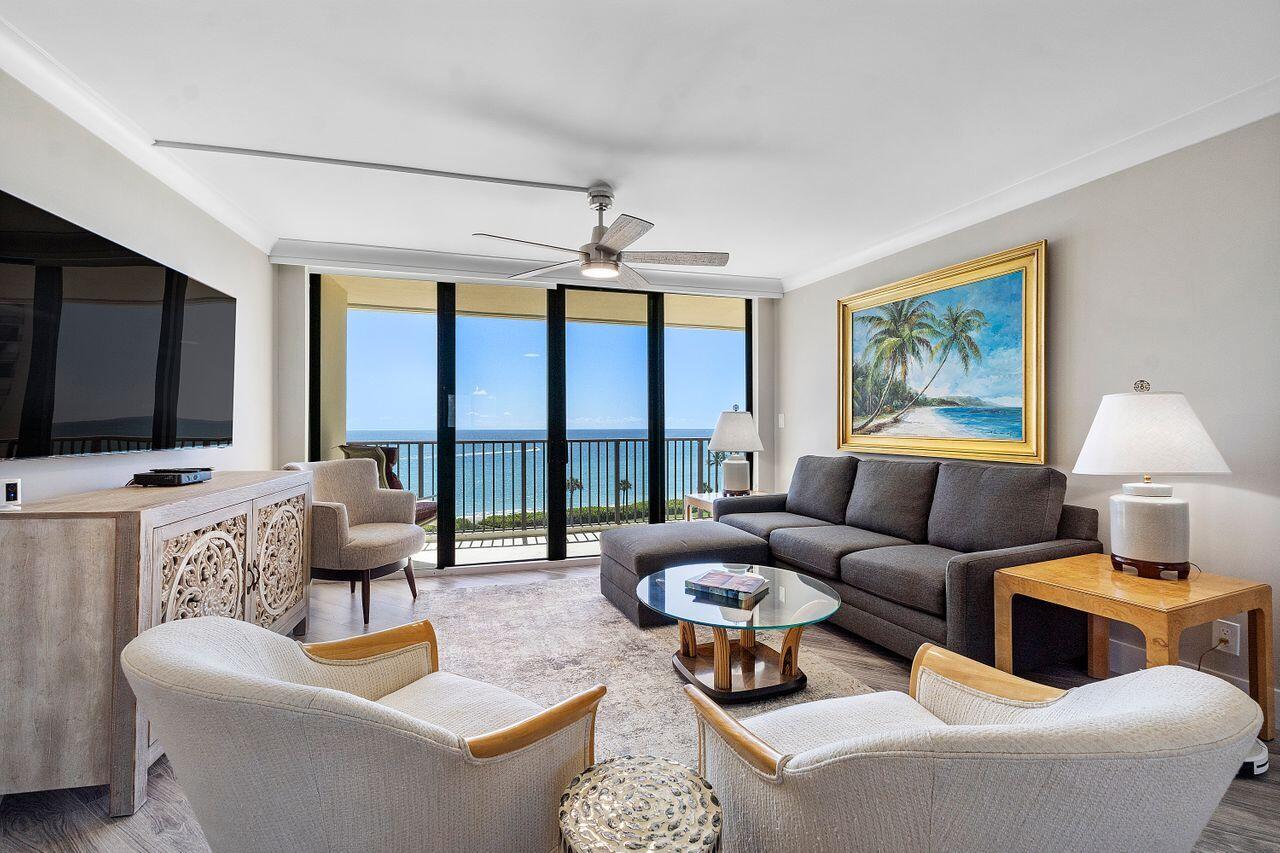 200 Ocean Trail Way, Unit 602 Jupiter, FL 33477 - Photo 3 of 50 a living room with furniture a flat screen tv and a large window
