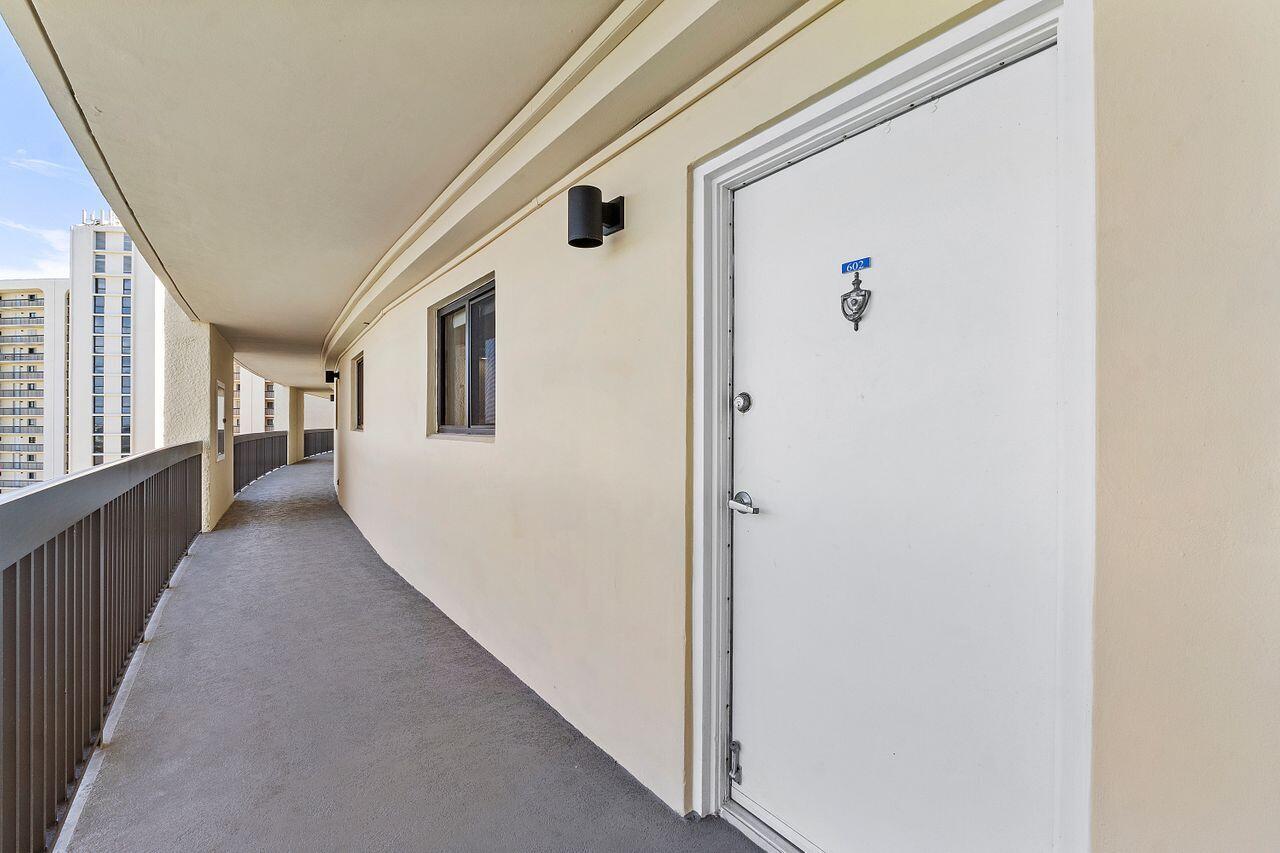 200 Ocean Trail Way, Unit 602 Jupiter, FL 33477 - Photo 40 of 50 a view of a hallway with wooden floor and windows