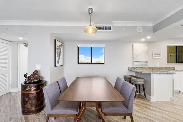 a view of a dining room with furniture and wooden floor
