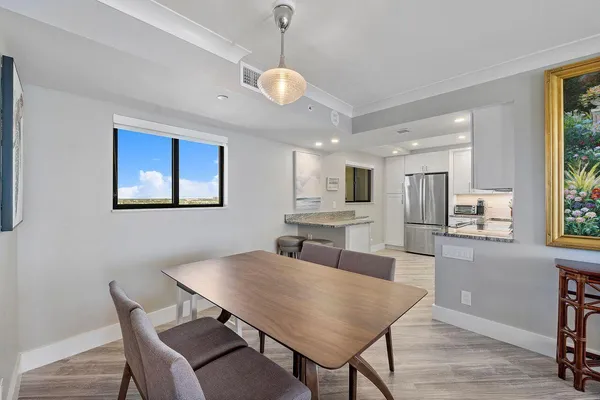 a view of a dining room with furniture and wooden floor