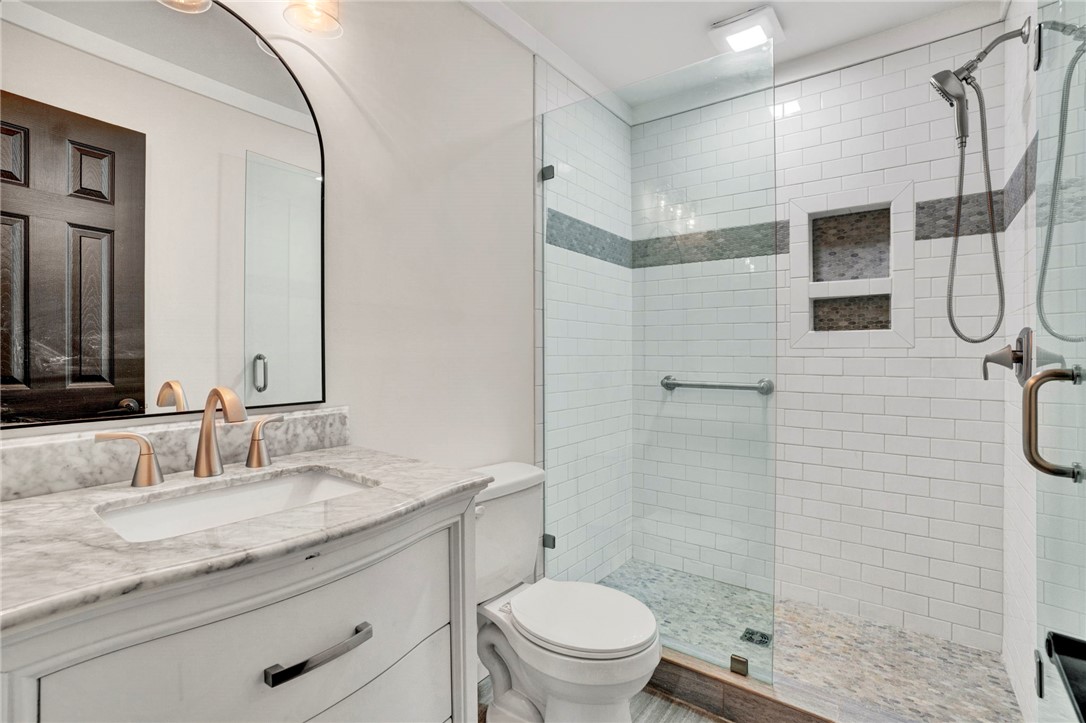 237 Earle Road Central, SC 29630 - Photo 20 of 24 Refined bathroom with a broad marble-topped vanity and a glass-enclosed walk-in shower.
