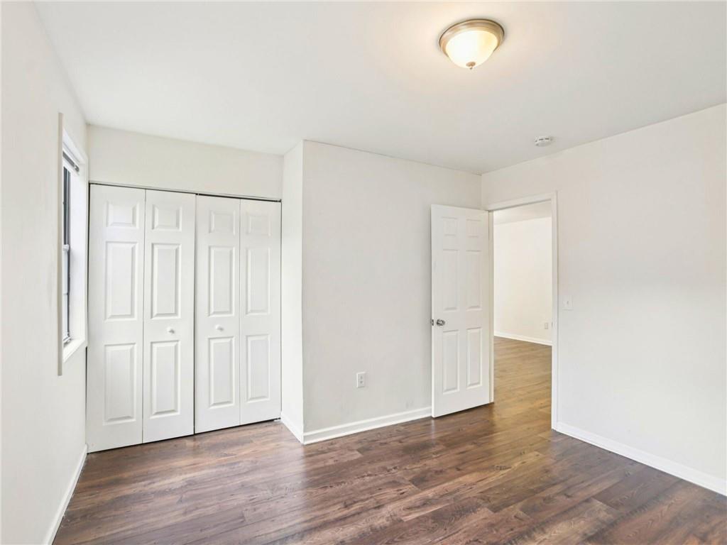 1918 West Kimberly Road Southwest Atlanta, GA 30331 - Photo 12 of 23 a view of an empty room with wooden floor