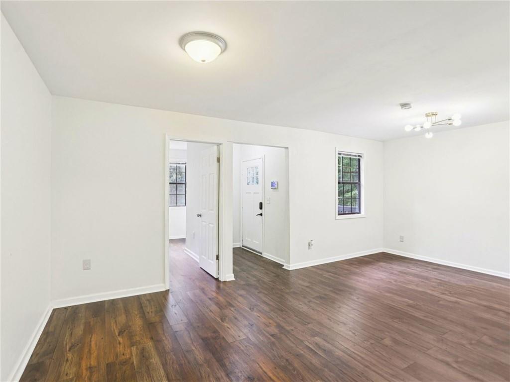 1918 West Kimberly Road Southwest Atlanta, GA 30331 - Photo 5 of 23 an empty room with wooden floor and windows