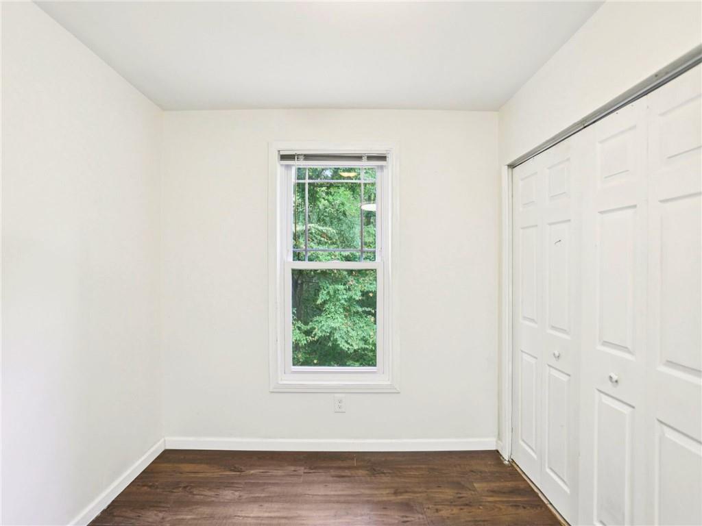 1918 West Kimberly Road Southwest Atlanta, GA 30331 - Photo 9 of 23 a view of an empty room with wooden floor and a window