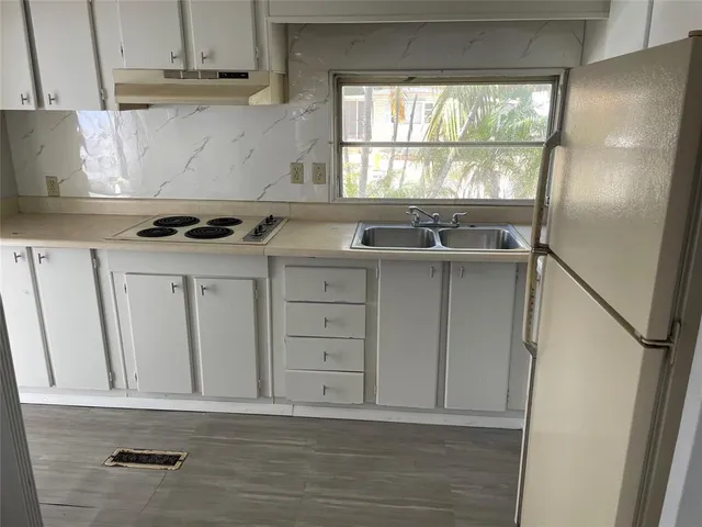 a view of a kitchen with a sink and a window