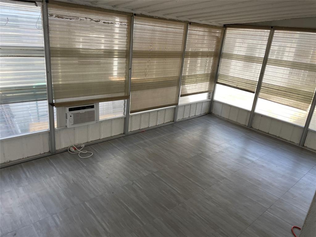 2875 Southwest 58th Street Dania Beach, FL 33312 - Photo 7 of 12 a view of an empty room with a window and wooden floor
