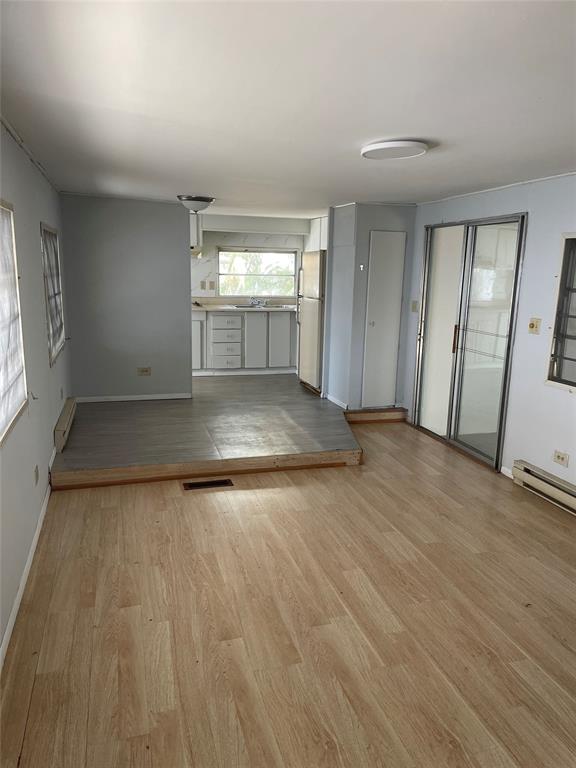 2875 Southwest 58th Street Dania Beach, FL 33312 - Photo 8 of 12 an empty room with wooden floor and windows