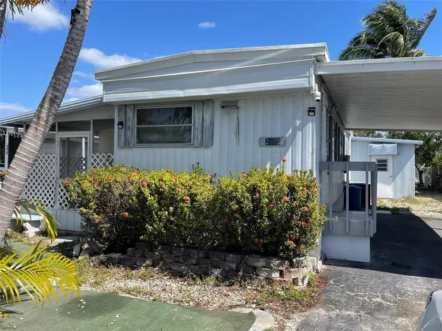 a view of a house with potted plants