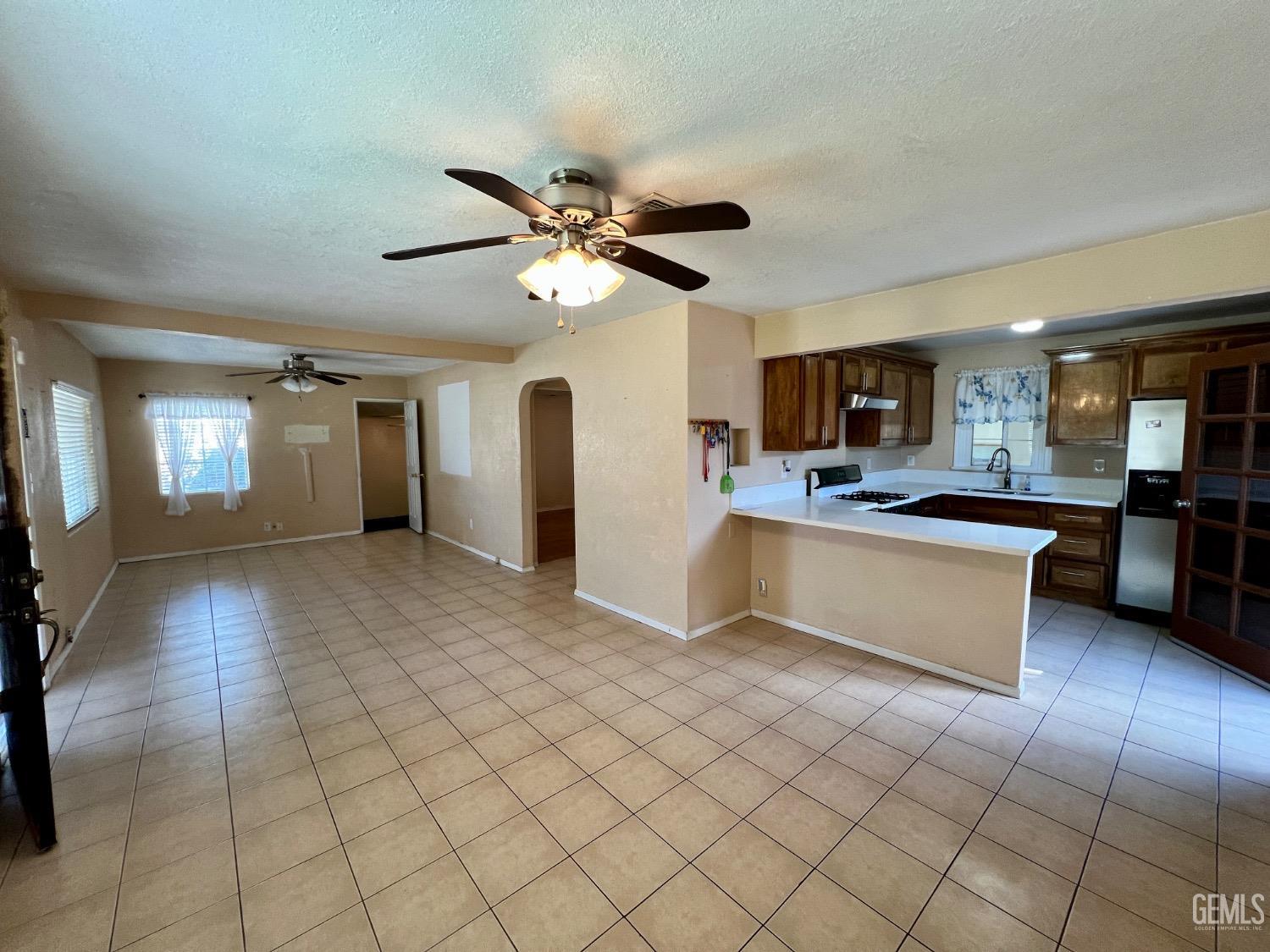 Undisclosed Address Wasco, CA 93280 - Photo 5 of 24 a large kitchen with cabinets and stainless steel appliances