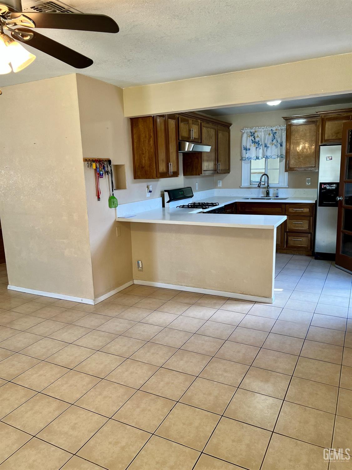 Undisclosed Address Wasco, CA 93280 - Photo 6 of 24 a view of kitchen with cabinets and window