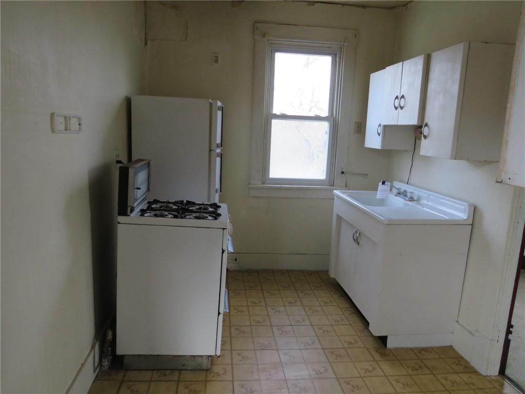 407 Linnview Avenue Pittsburgh, PA 15210 - Photo 13 of 38 a utility room with cabinets washer and dryer