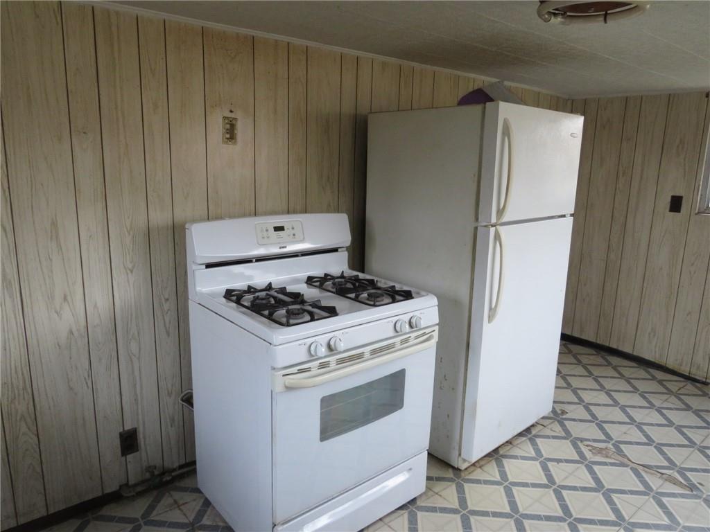 407 Linnview Avenue Pittsburgh, PA 15210 - Photo 18 of 38 a kitchen with a stove and a refrigerator
