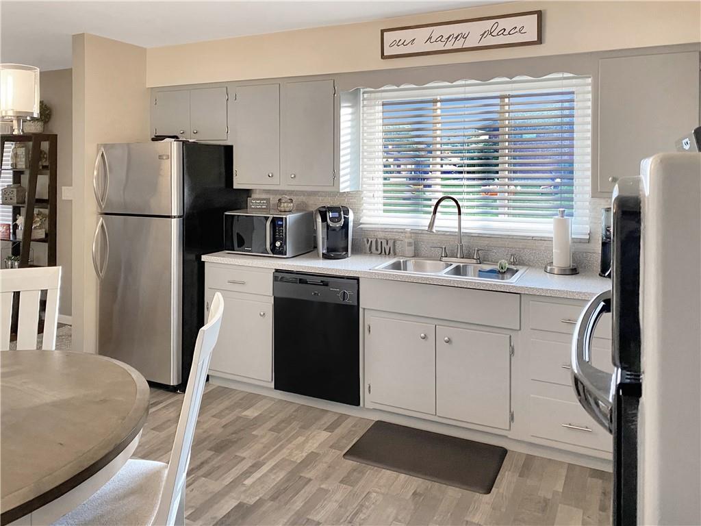 2399 Ridge Road Monaca, PA 15061 - Photo 6 of 20 a kitchen with a sink a refrigerator a stove a washer and dryer