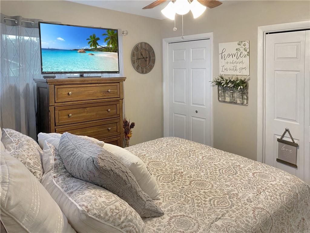 2399 Ridge Road Monaca, PA 15061 - Photo 9 of 20 a bedroom with a bed and a chandelier