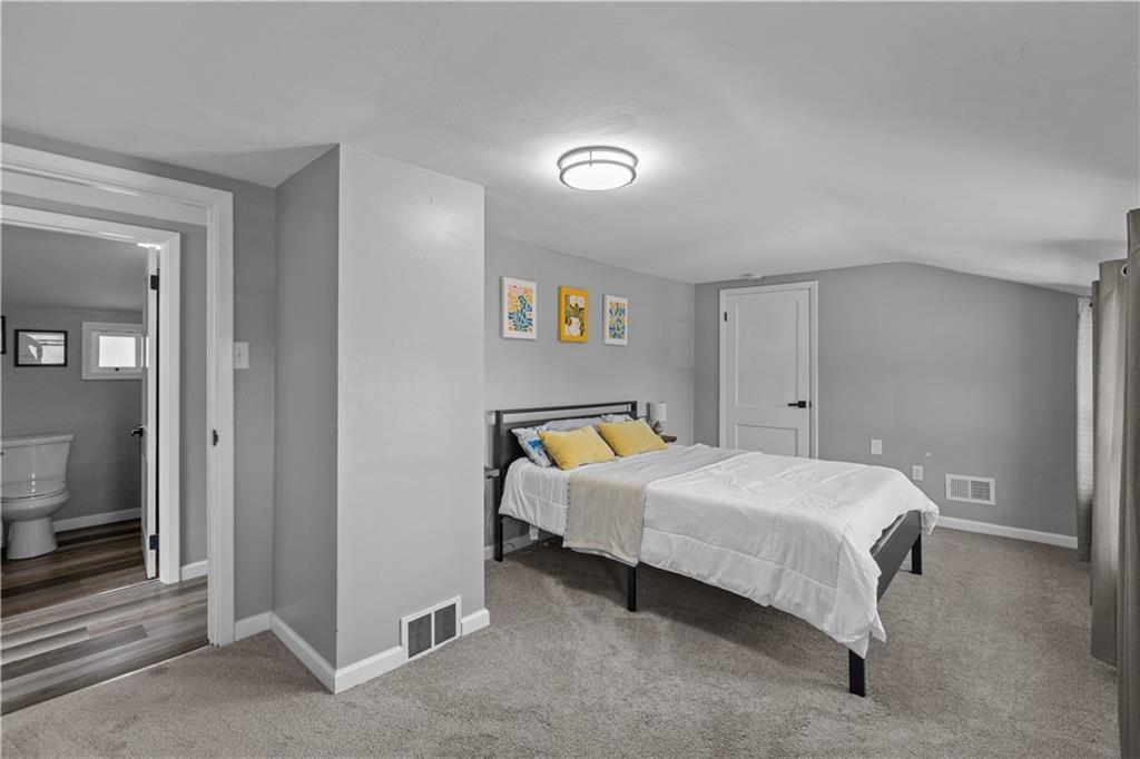 5575 Aiken Road McKees Rocks, PA 15136 - Photo 19 of 33 a bedroom with a bed and a lamp