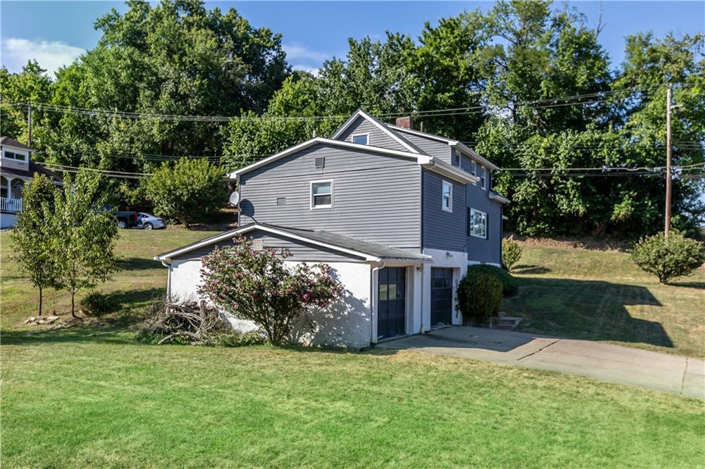 5575 Aiken Road McKees Rocks, PA 15136 - Photo 3 of 33 a front view of a house with a yard and garage
