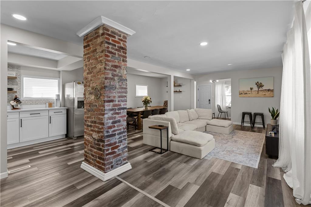 5575 Aiken Road McKees Rocks, PA 15136 - Photo 7 of 33 a living room with furniture a large window and wooden floor