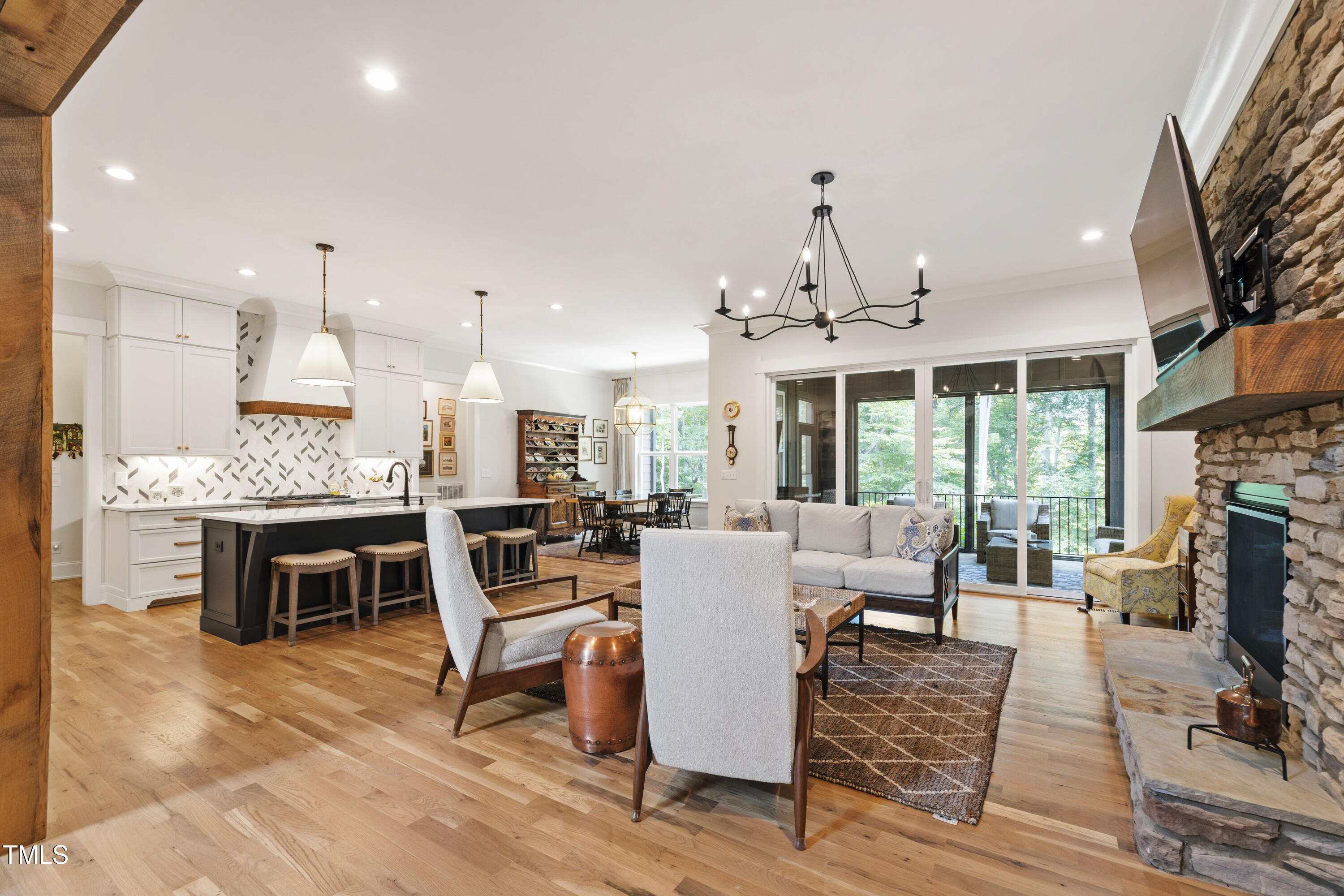 541 Sunset Grove Drive Pittsboro, NC 27312 - Photo 13 of 75 a living room with furniture a fireplace a flat screen tv and windows