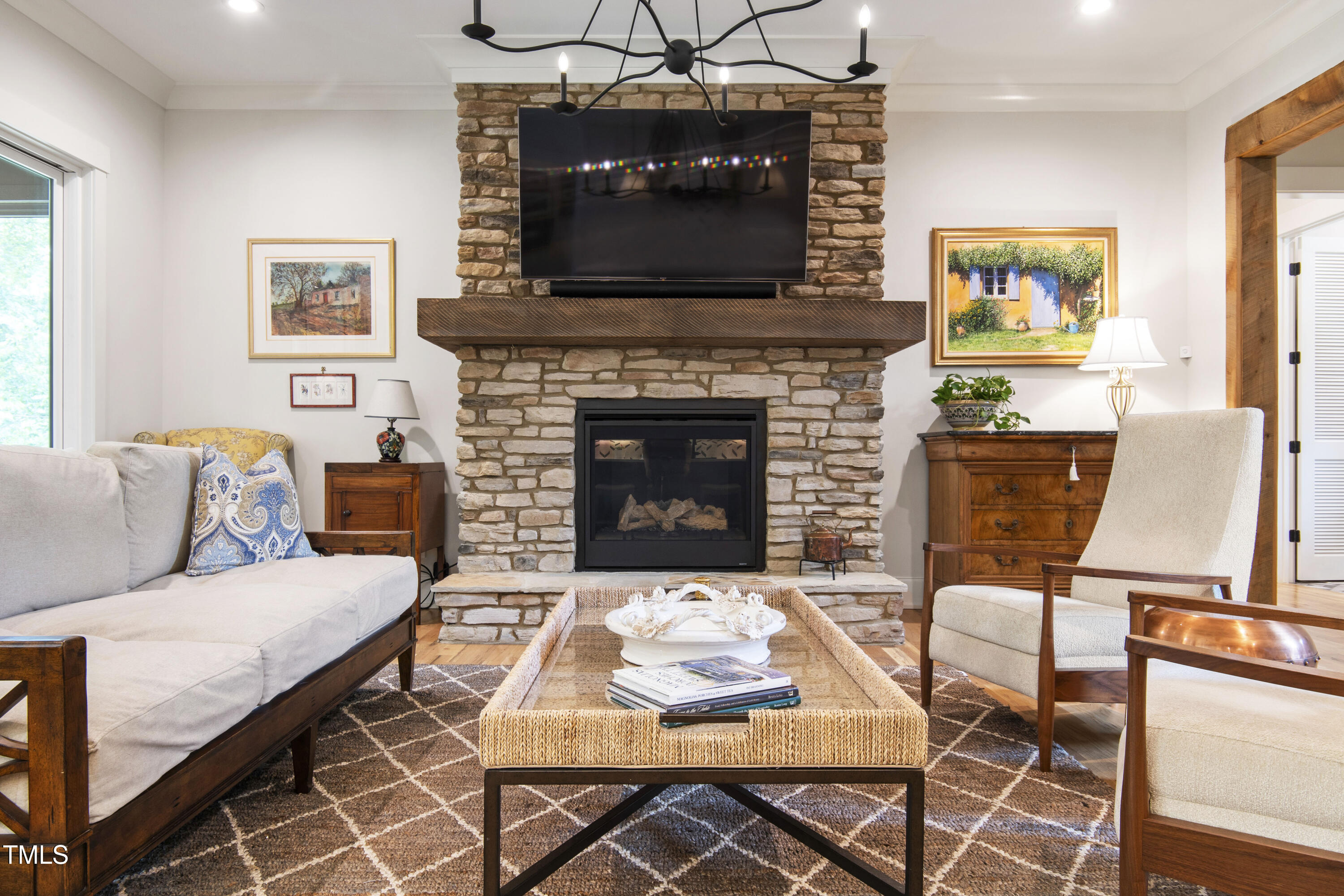 541 Sunset Grove Drive Pittsboro, NC 27312 - Photo 14 of 75 a living room with furniture a flat screen tv and a fireplace