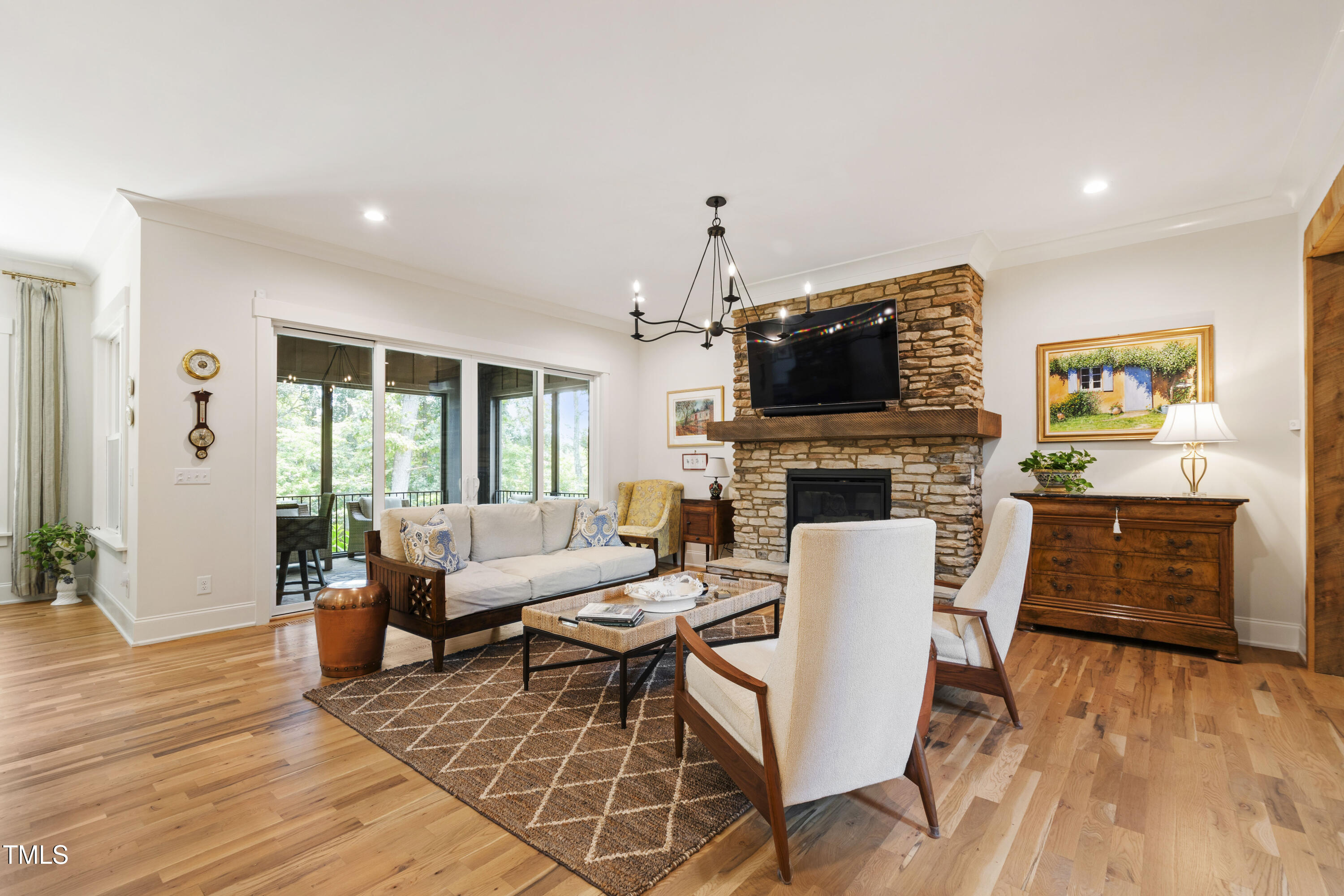 541 Sunset Grove Drive Pittsboro, NC 27312 - Photo 15 of 75 a living room with furniture a fireplace and a flat screen tv