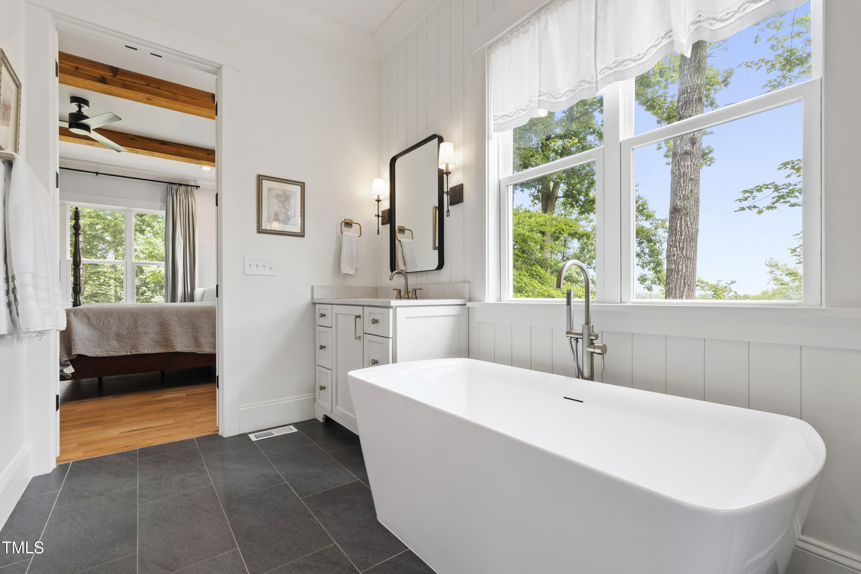 541 Sunset Grove Drive Pittsboro, NC 27312 - Photo 29 of 75 a bathroom with a tub a sink and a window