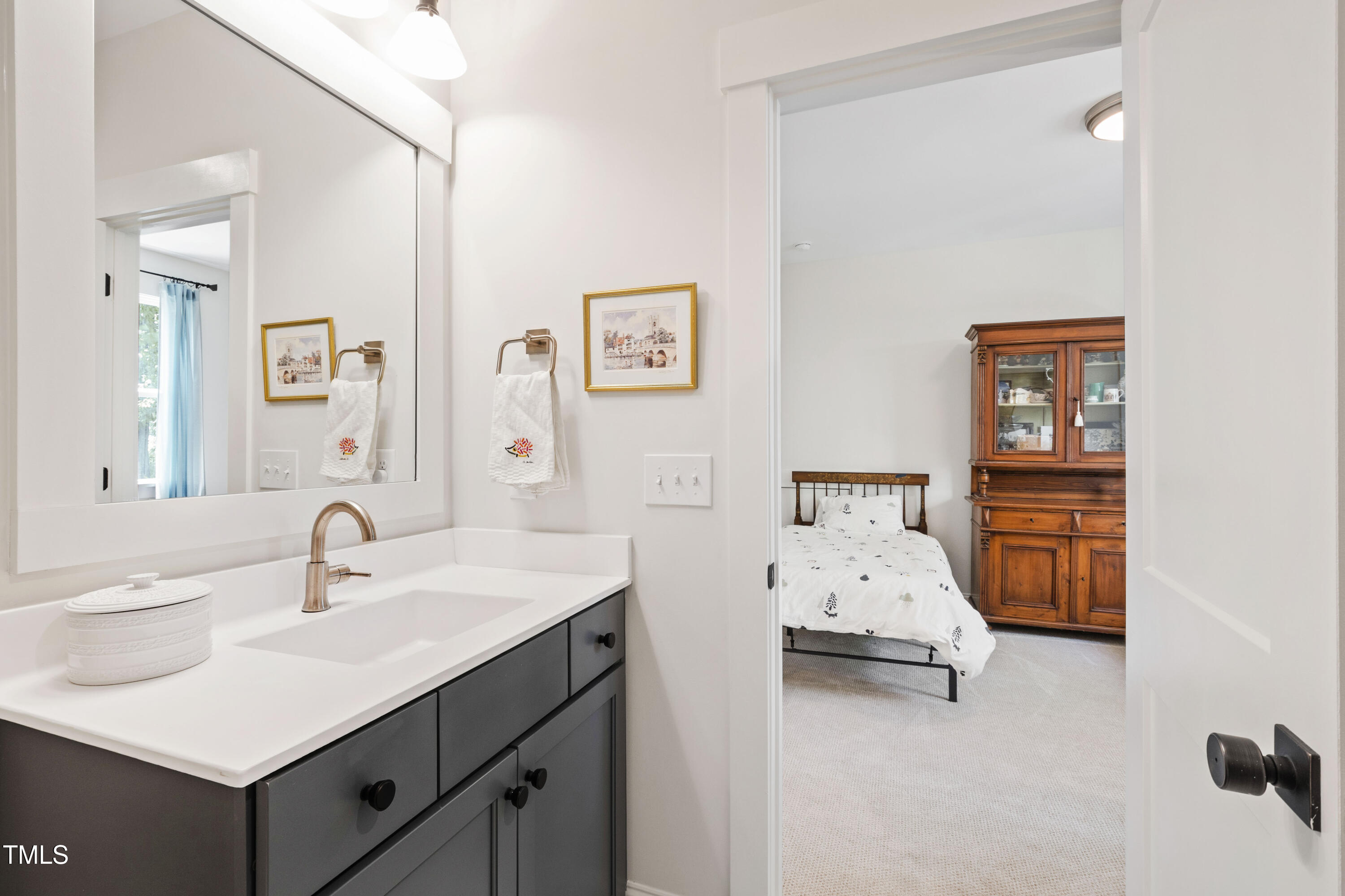 541 Sunset Grove Drive Pittsboro, NC 27312 - Photo 48 of 75 a en suite bathroom with a sink and a mirror