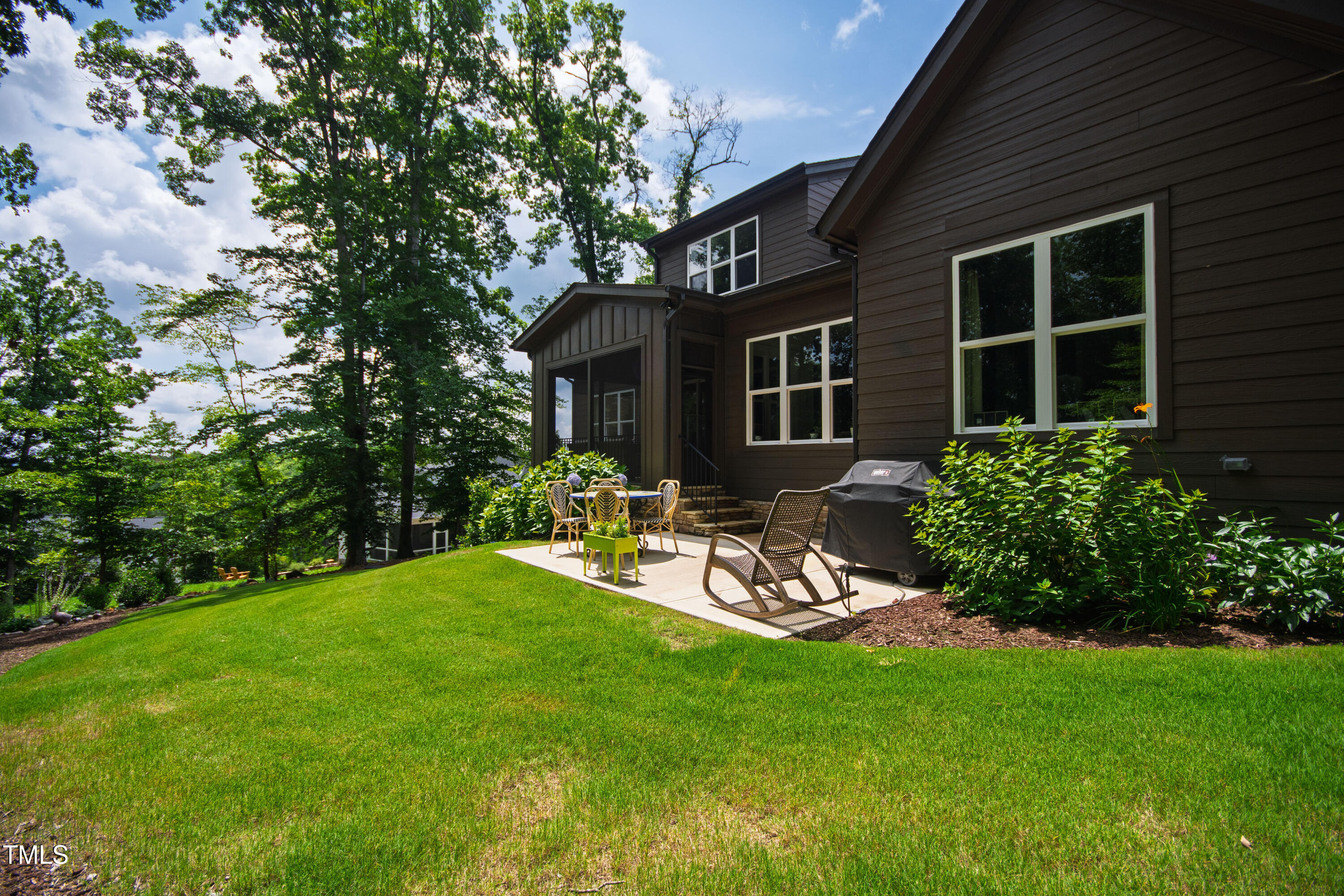 541 Sunset Grove Drive Pittsboro, NC 27312 - Photo 58 of 75 a view of a backyard with table and chairs wooden fence