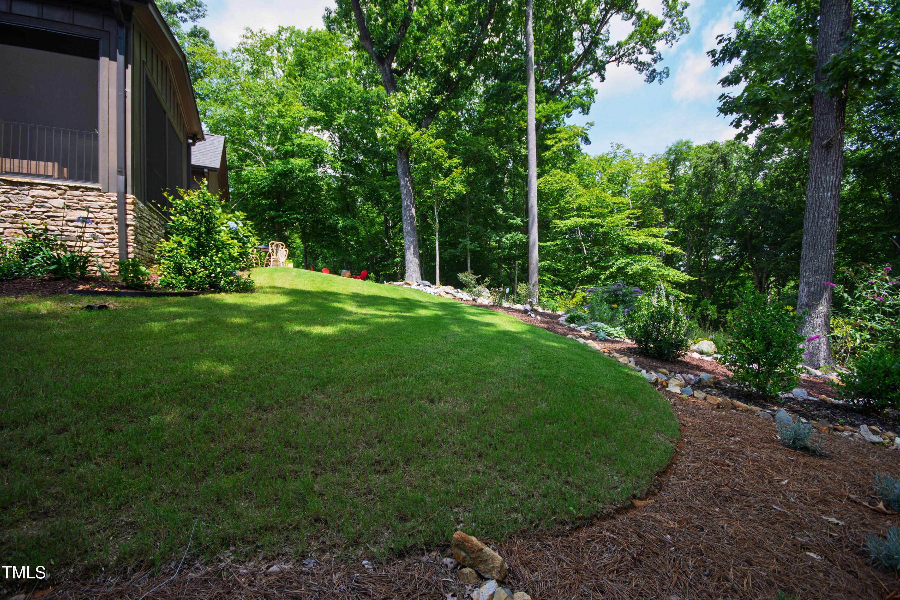 541 Sunset Grove Drive Pittsboro, NC 27312 - Photo 60 of 75 a view of a backyard with potted plants and large trees