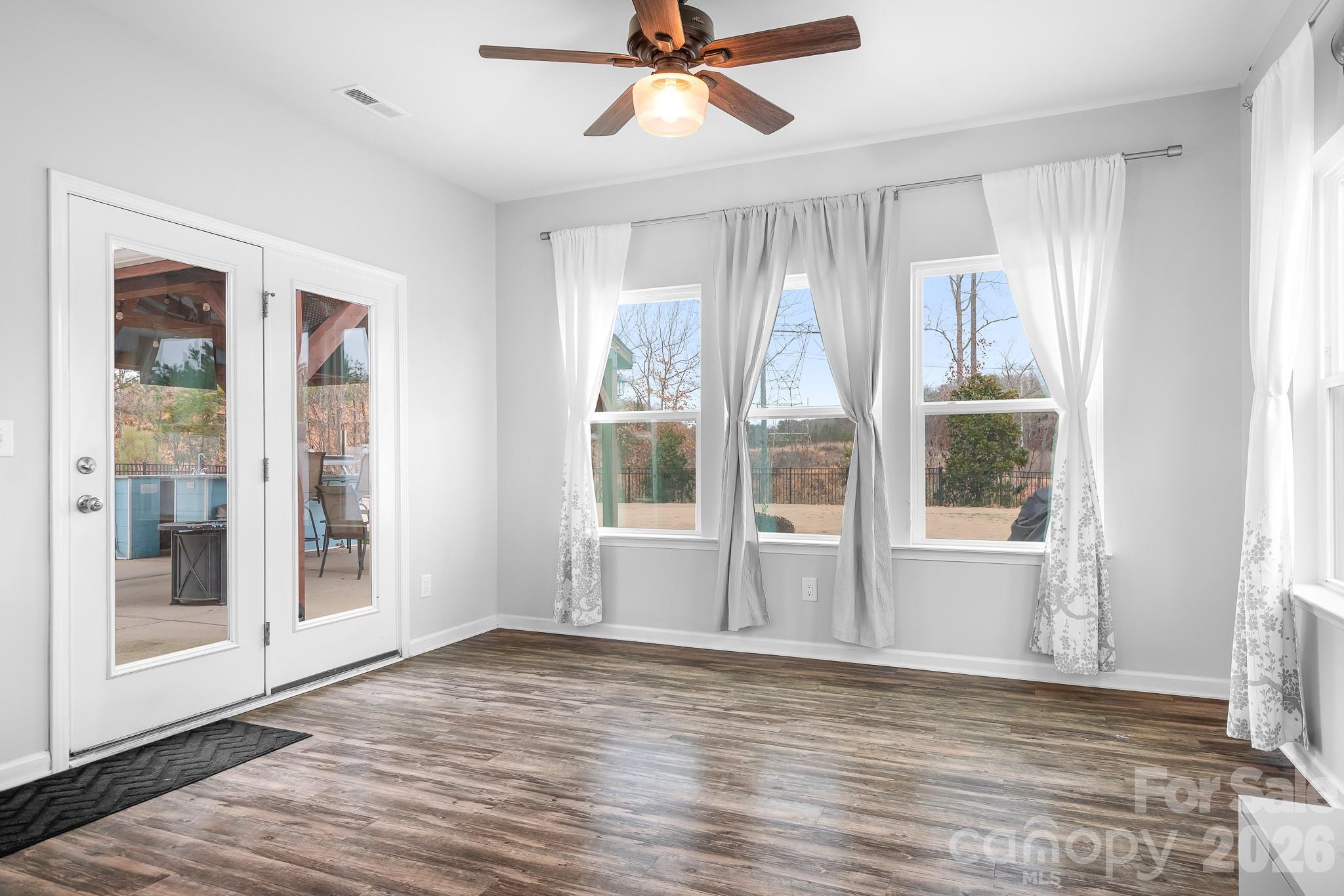 6308 Durango Way Denver, NC 28037 - Photo 11 of 45 a view of an empty room with a window and wooden floor