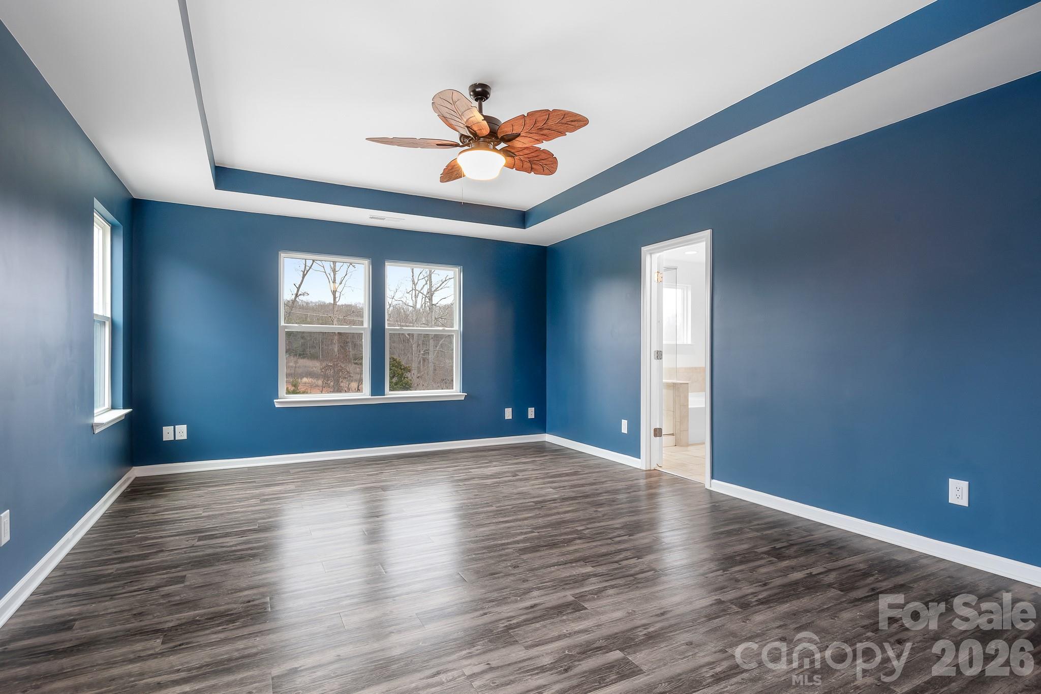 6308 Durango Way Denver, NC 28037 - Photo 14 of 45 a view of an empty room with window and wooden floor