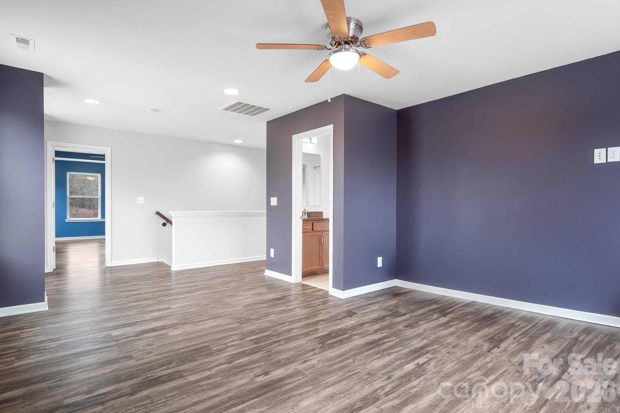 6308 Durango Way Denver, NC 28037 - Photo 19 of 45 a view of an empty room with window and wooden floor