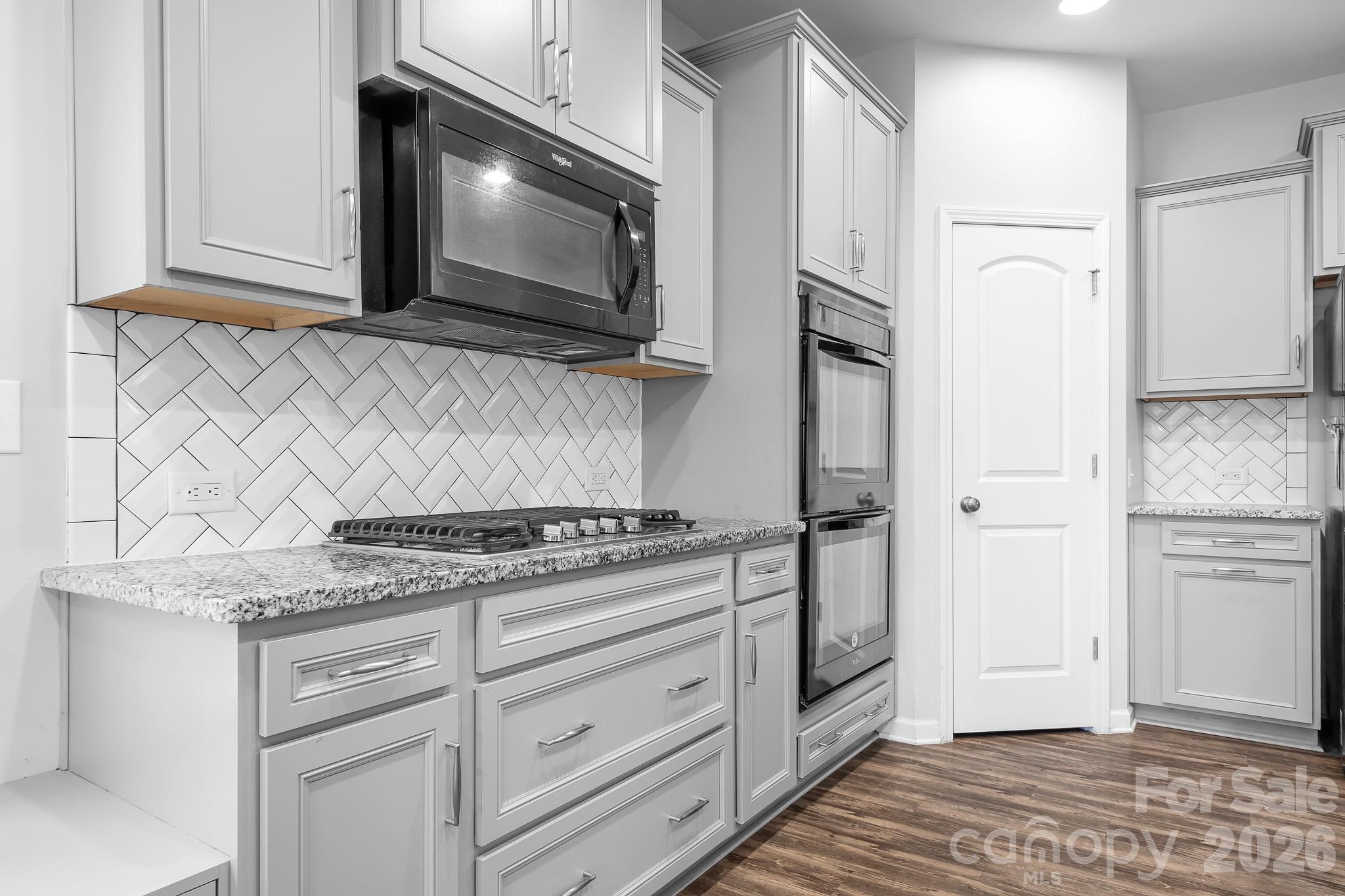 6308 Durango Way Denver, NC 28037 - Photo 5 of 45 a kitchen with stainless steel appliances white cabinets and a stove top oven