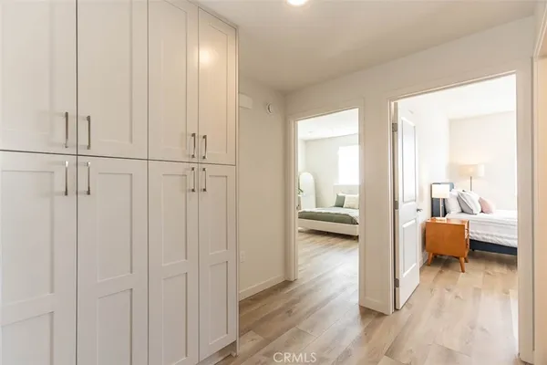 a view of a bedroom with furniture and wooden floor