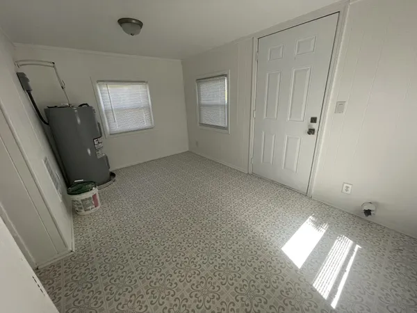a kitchen with granite countertop a refrigerator stove and microwave