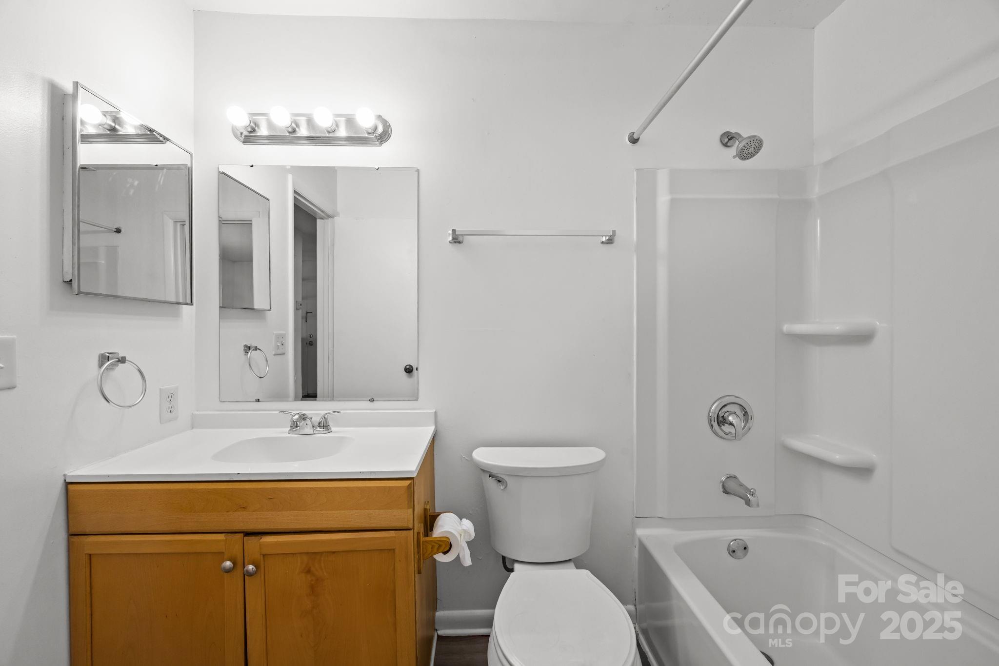 4902 Spring Lake Drive, Unit D Charlotte, NC 28212 - Photo 19 of 30 a bathroom with a sink a toilet and shower