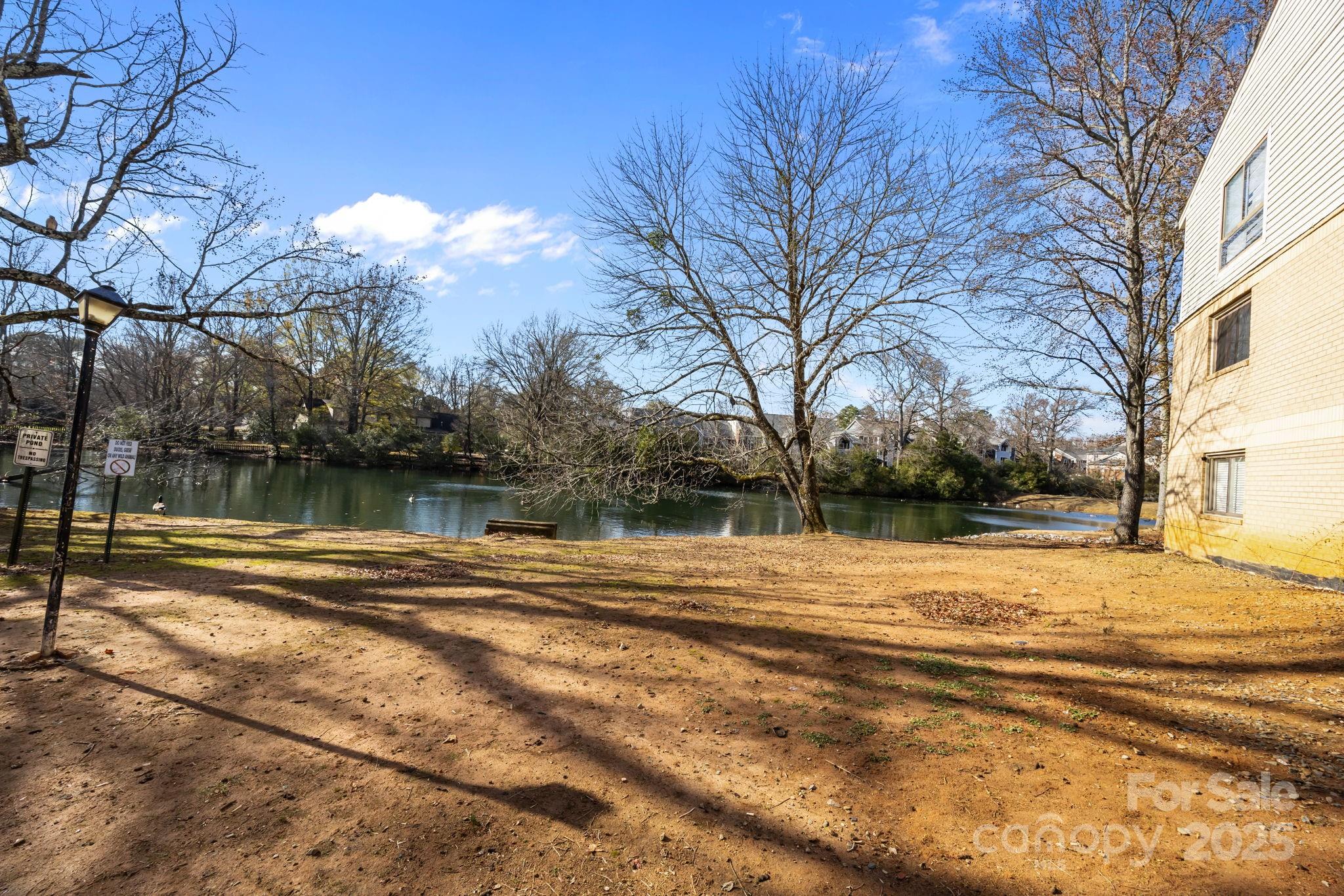 4902 Spring Lake Drive, Unit D Charlotte, NC 28212 - Photo 2 of 30 a view of a yard with a house and trees in the background
