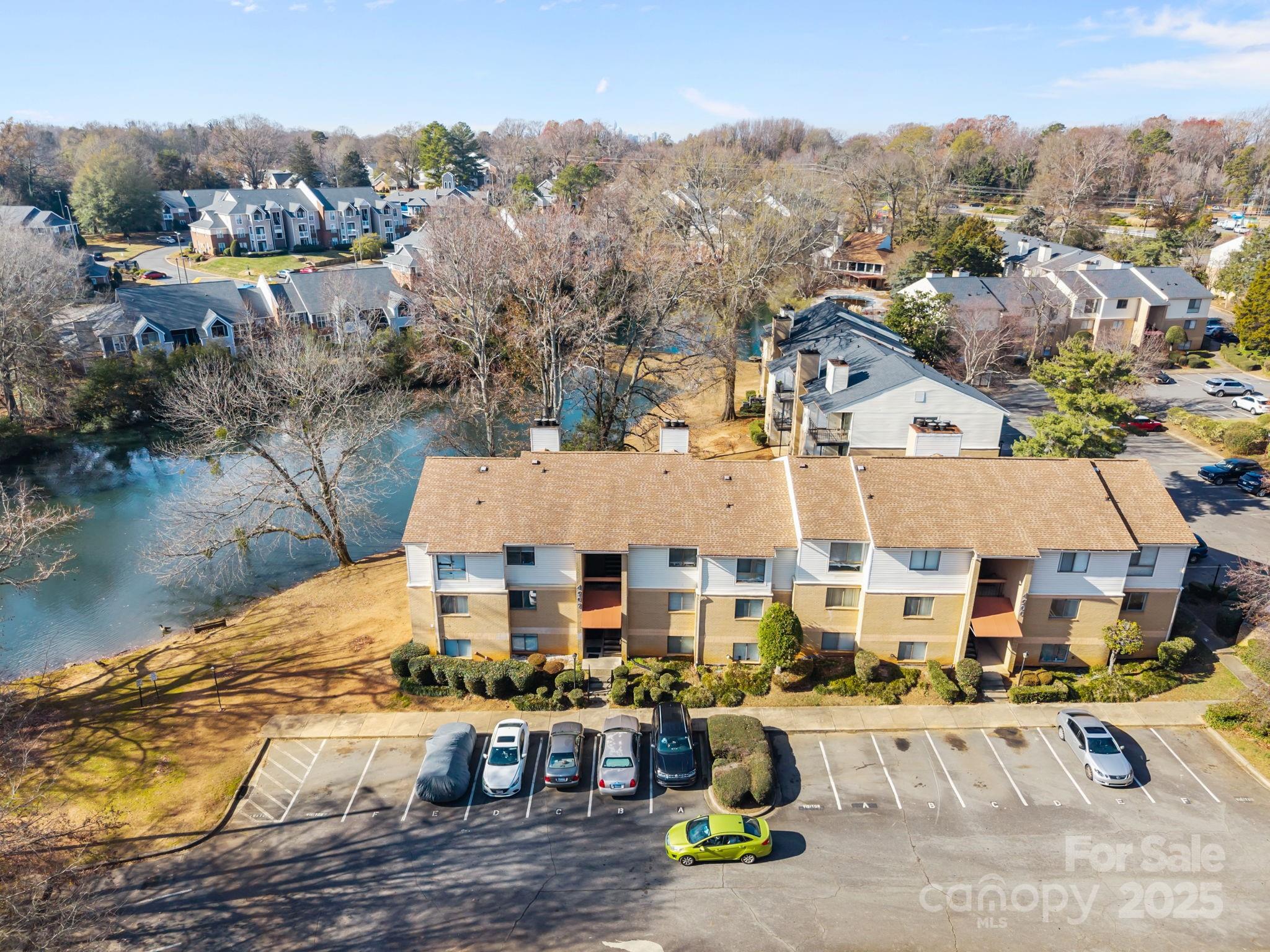 4902 Spring Lake Drive, Unit D Charlotte, NC 28212 - Photo 27 of 30 an aerial view of residential houses with outdoor space and lake view