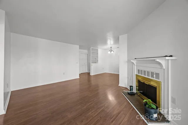 wooden floor in an empty room with a fireplace