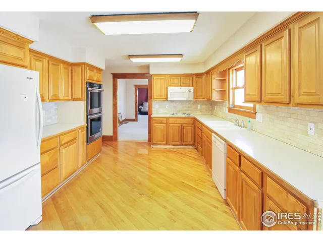 a bathroom with a sink and a refrigerator