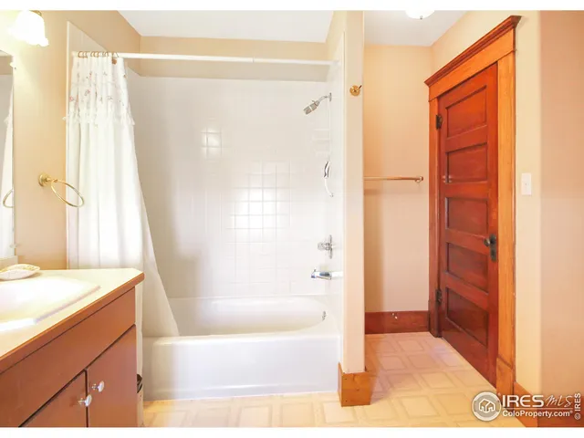 a view of a room with wooden floor and windows