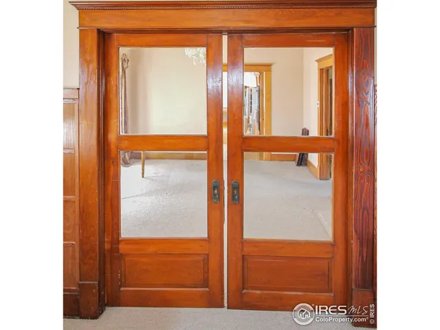 a living room with a furniture and a large window