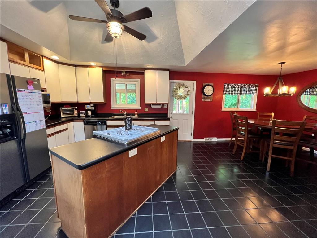 100 Randy Drive Butler, PA 16002 - Photo 8 of 25 a kitchen with stainless steel appliances granite countertop a sink a counter space cabinets and a window