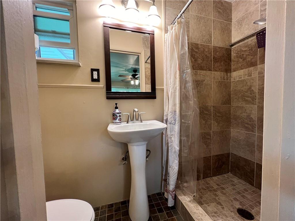 100 Randy Drive Butler, PA 16002 - Photo 10 of 25 a bathroom with a sink mirror toilet and shower