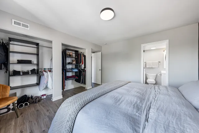 a bedroom with a bed and a book shelf