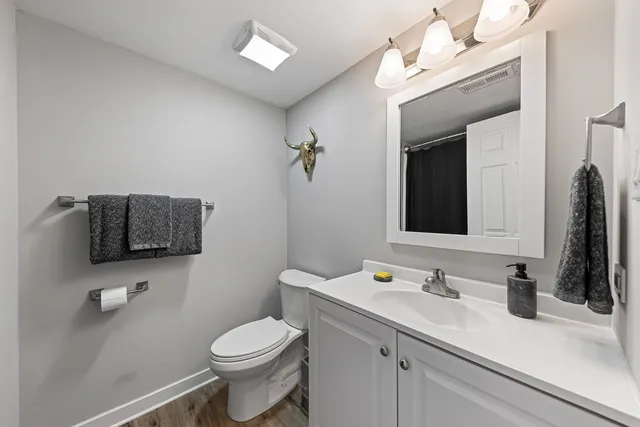 a bathroom with a toilet sink and mirror