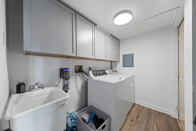 a utility room with sink dryer and washer
